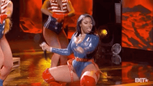 Superhero Woman Kneeling With Microphone GIF