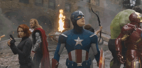 Superheros Including Captain America Standing Before Fire