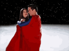 Superman Hugging A Woman With His Cape GIF