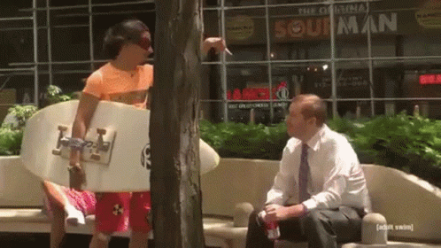Surfboard Man Talking To Man At Original Sour Man GIF