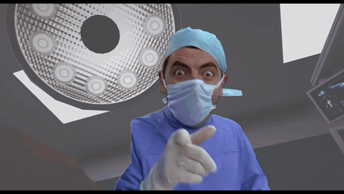 Surgeon in Mask and Gloves Pointing at Camera