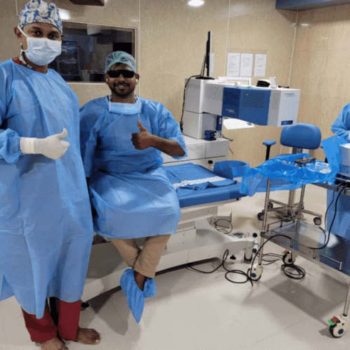 Surgeon Thumbs Up, Another on Operating Table
