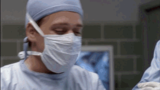 Surgeon Wearing Mask And Gown GIF