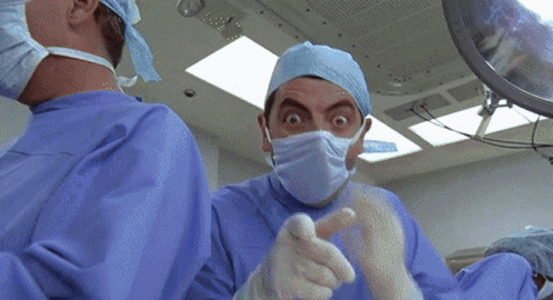 Surgeon With Mask and Gloves Looking at Camera