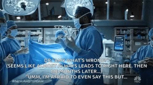 Surgeons Talking Operating Room Wearing Masks and Gloves