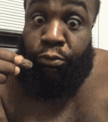 Surprised Bearded Man Holding Something