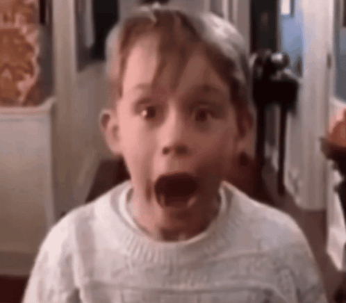 Surprised Boy in White Sweater