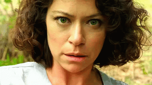 Surprised Curly-Haired Woman Looking at Camera