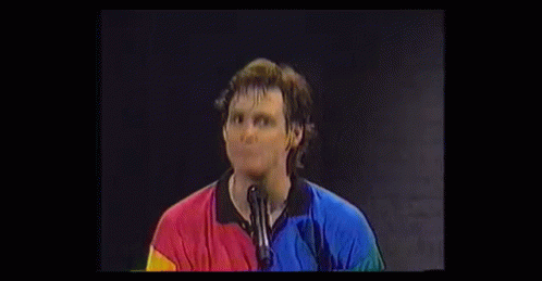 Surprised Man In Colorful Shirt With Hands GIF