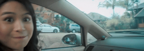 Surprised Woman in Car Looking Out Window