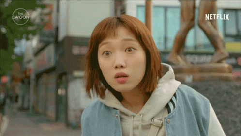 Surprised Woman In Front Of Statue And Netflix Logo GIF