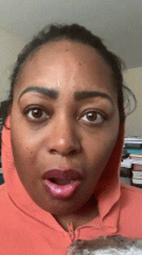 Surprised Woman in Orange Hoodie