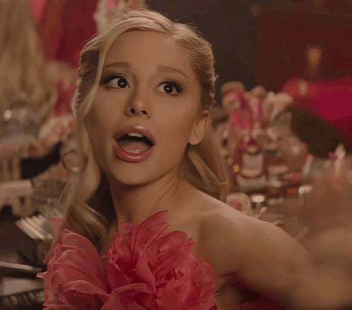 Surprised Woman In Pink Dress With Flower GIF