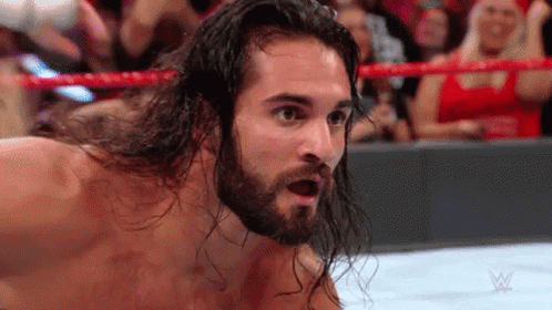 Surprised Wrestler with Long Hair and Beard in Crowd