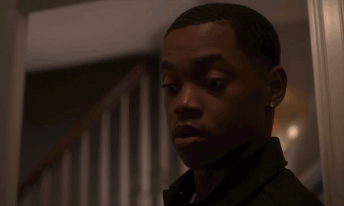 Surprised Young Man In Front Of Staircase GIF