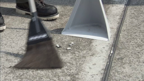 Man In White Coat Doing Sweep In The Street GIF