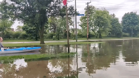Sweet Lady Riding Boat In Monsoon Flood GIF