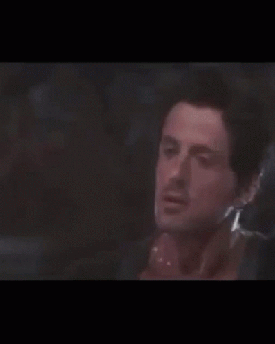 Sylvester Stallone Putting Hat Backward Over The Top GIF
