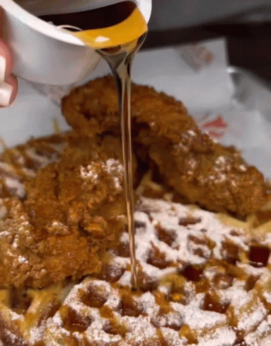 Syrup Is Poured Over A Waffle With Powdered Sugar GIF