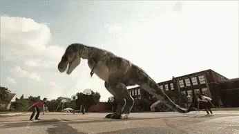 T-Rex Jumping Over Skateboarders In Parking Lot GIF