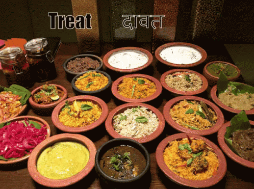 Table Full of Bowls of Food Saying Treat