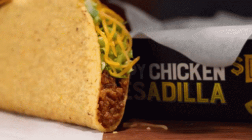 Taco Next to Box Saying Chicken Sadilla