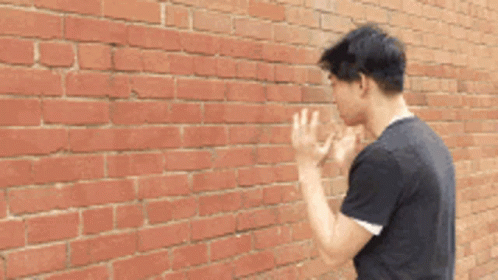 Talking To A Wall Asian Guy GIF