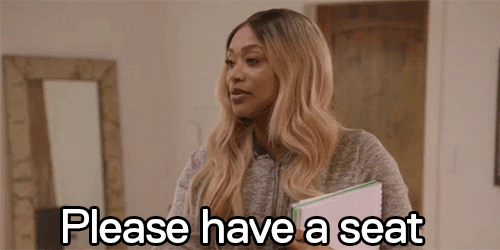 Tami Roman Inviting Guest To Sit Down GIF