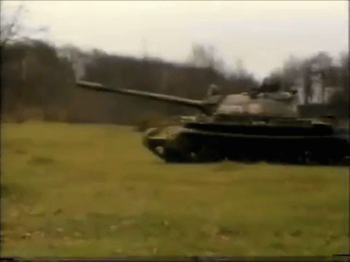 Tank Driving Through Field With Trees GIF