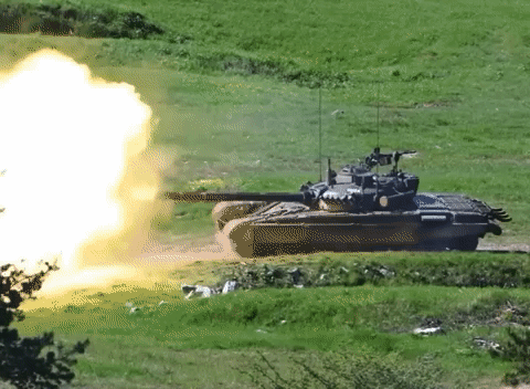 Tank Firing Rocket in Grass Field