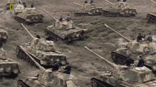 Tanks Lined Up in Field With National Geographic Logo