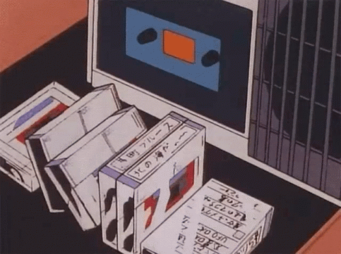 Tapes Sitting on Table Next to Computer