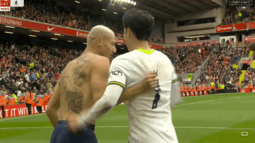 Tattooed Man Shaking Hands on Soccer Field