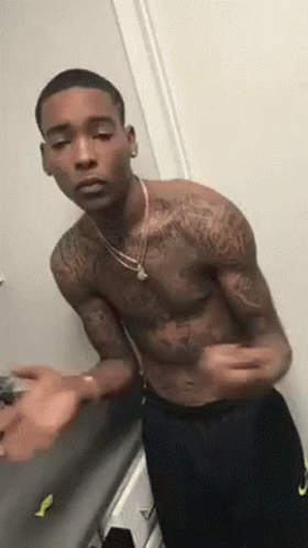Tattooed Shirtless Man in Mirror