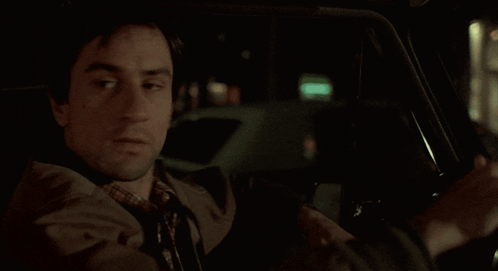 Taxi Driver Travis Bickle Looking Behind While Driving GIF
