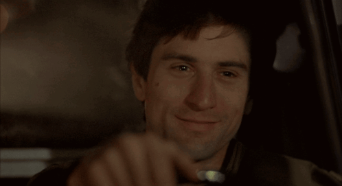 Taxi Driver Travis Bickle Smiling While Driving GIF