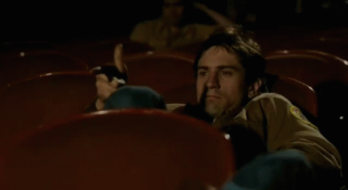 Taxi Driver Travis Bickle Watching Movie GIF