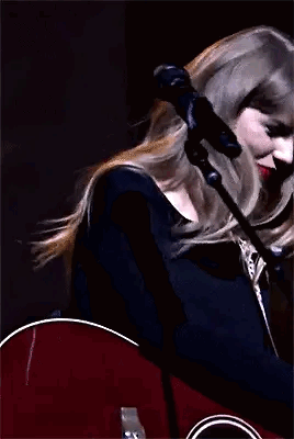 Taylor Swift Holding Guitar and Waving