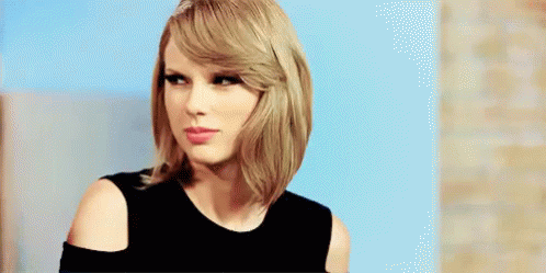 Taylor Swift In Black Dress Looking At Camera GIF