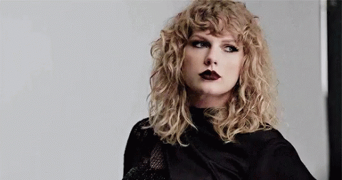 Taylor Swift in Black Shirt and Black Lipstick with Curly Hair