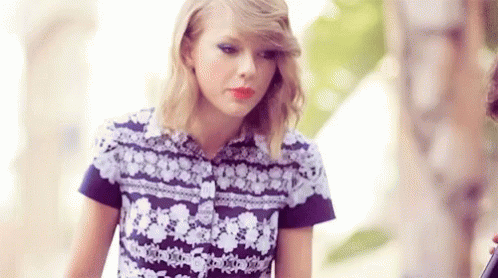 Taylor Swift In Purple White Floral Shirt With Man GIF