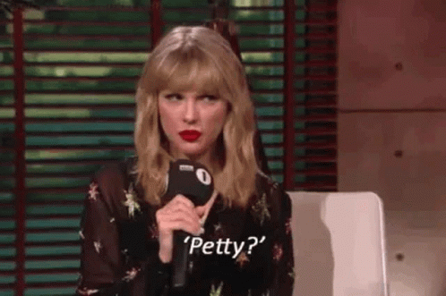 Taylor Swift Is Sitting In Front Of A Microphone And Talking Into It . GIF
