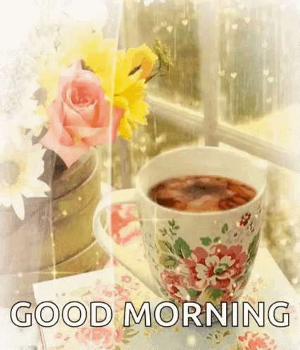 Tea Cup and Vase of Flowers Near Window