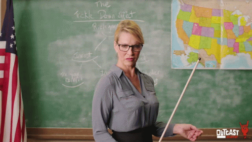 Teacher Standing In Front Of Tickle Down Effect Chalkboard GIF