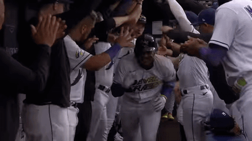 Teammates Congratulate Baseball Player After Home Run