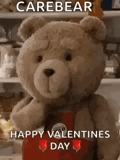 Teddy Bear In Red Apron Holding Rose GIF