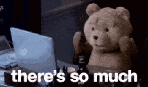 Teddy Bear Sitting at Desk with Laptop