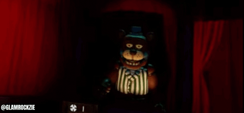 Teddy Bear Standing In Front Of Red Curtain GIF