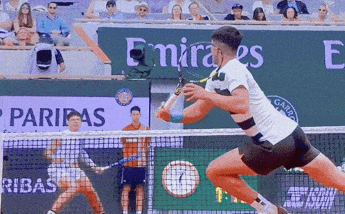 Tennis Match in Front of Emirates Sign