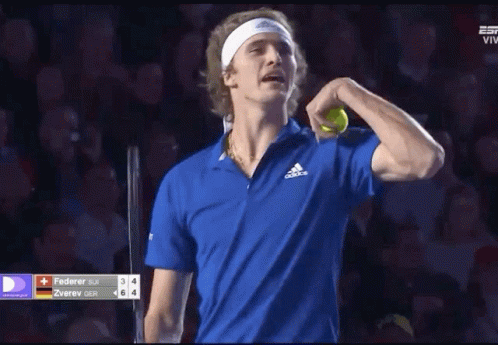 Tennis Player in Blue Adidas Shirt Holding Tennis Ball